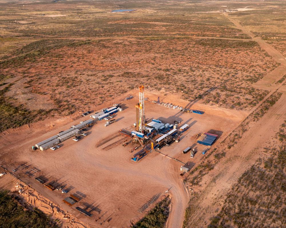 Overhead view of an oil well in an arid landscape