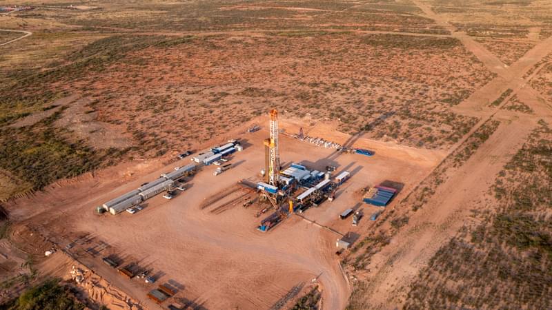 Overhead view of an oil well in an arid landscape